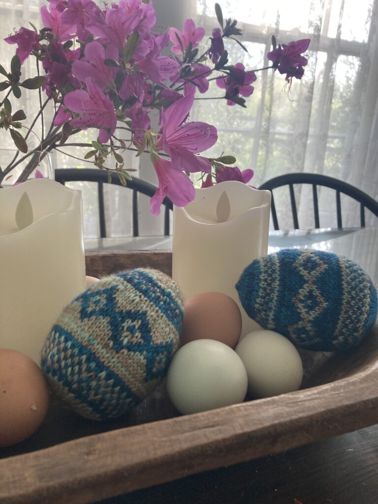 knitted easter eggs and real eggs
